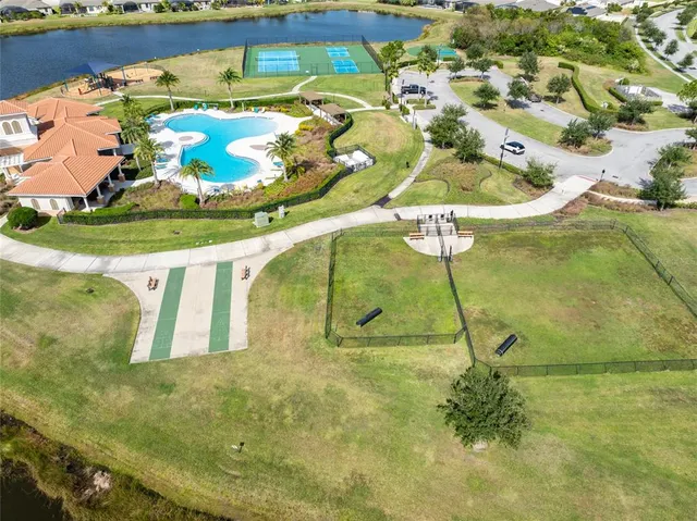 a view of a pool with a dining table and chairs