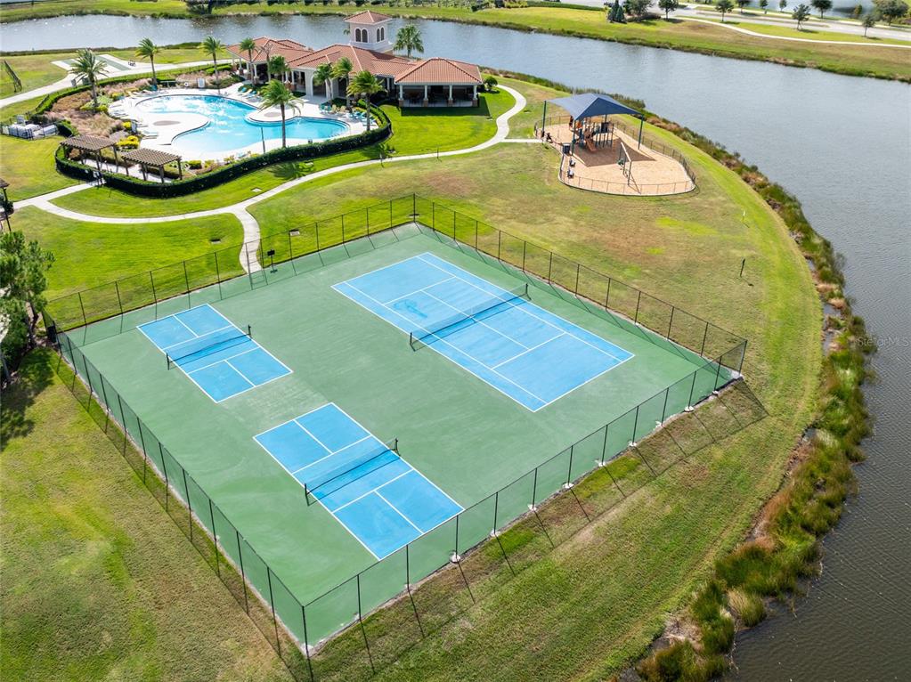 5127 Sable Chime Drive Wimauma, FL 33598 - Photo 53 of 56 a view of a pool with a dining table and chairs