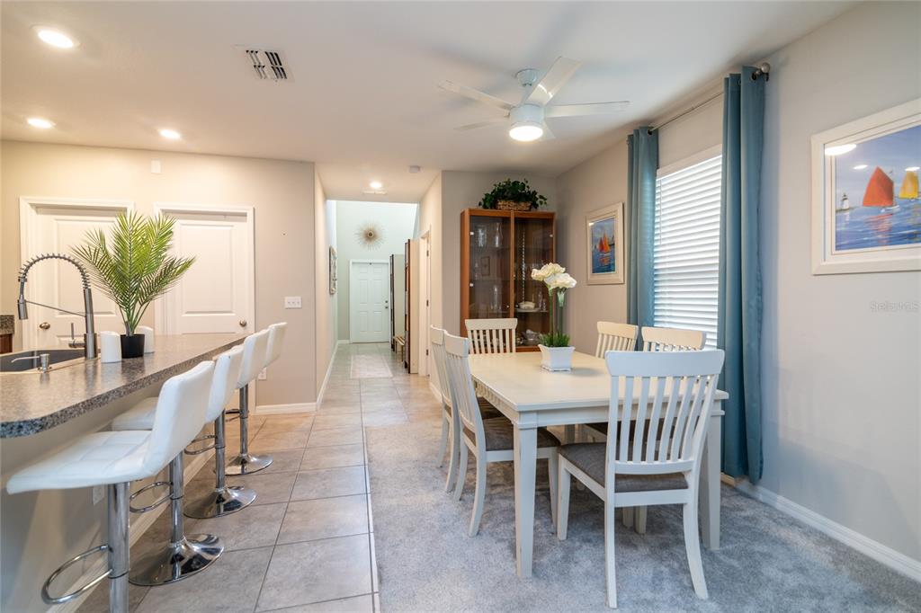 5127 Sable Chime Drive Wimauma, FL 33598 - Photo 8 of 56 a dining room with furniture and window