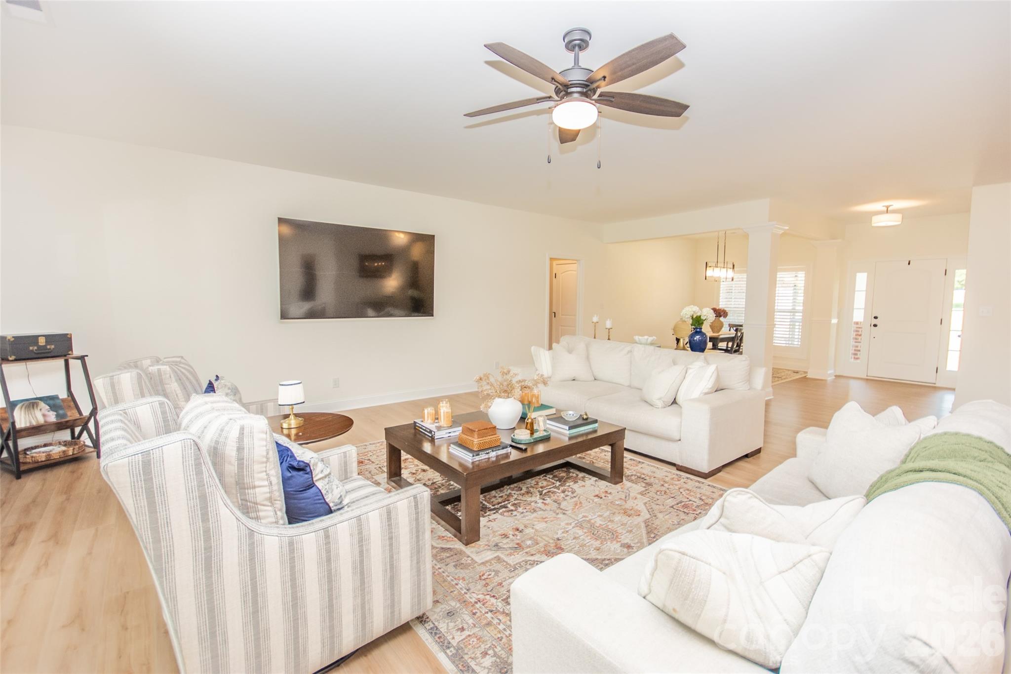 540 New Salem Road, Unit 1011 Statesville, NC 28625 - Photo 12 of 36 a living room with furniture a rug and a chandelier