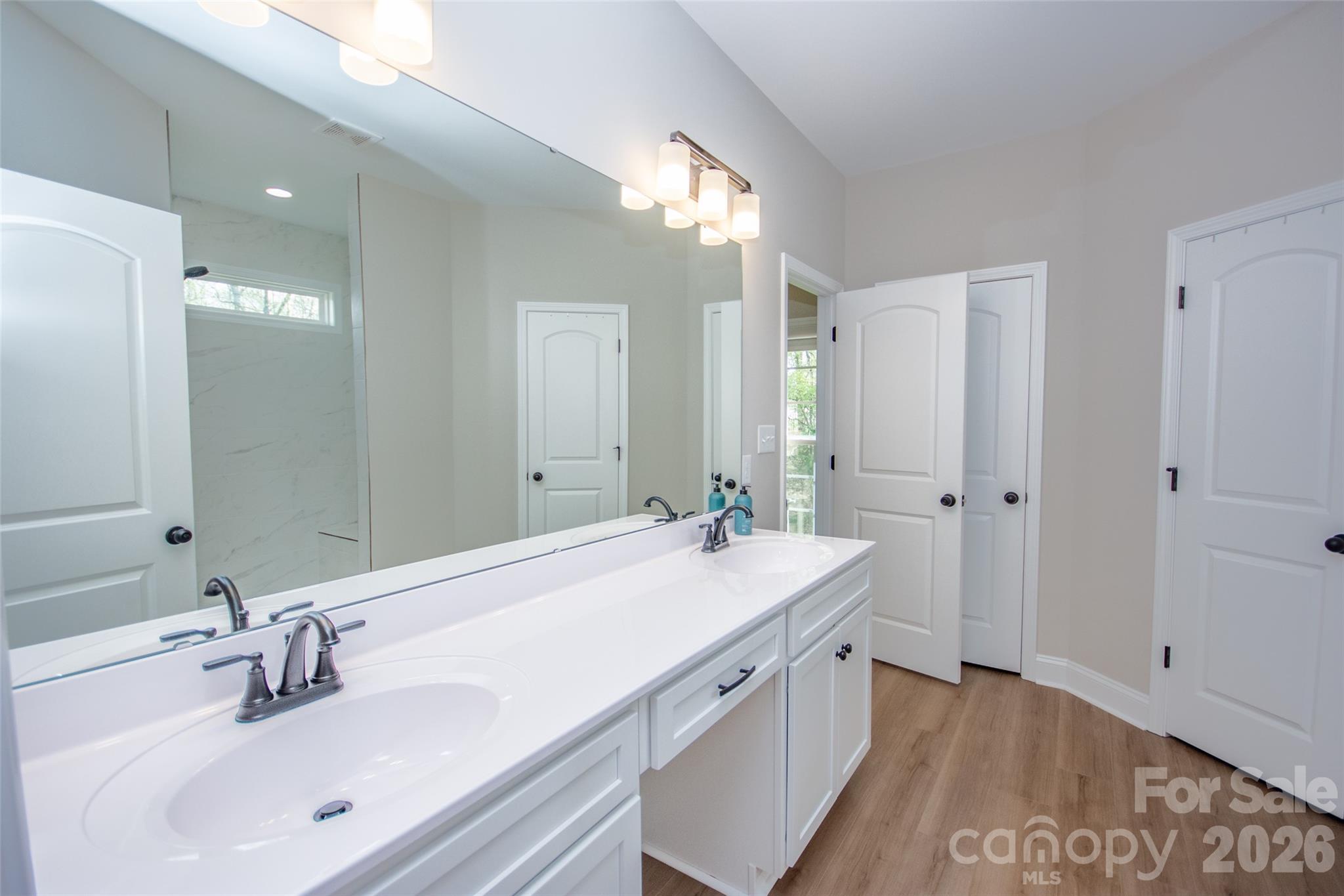 540 New Salem Road, Unit 1011 Statesville, NC 28625 - Photo 22 of 36 a bathroom with a sink double vanity granite tub shower and a mirror