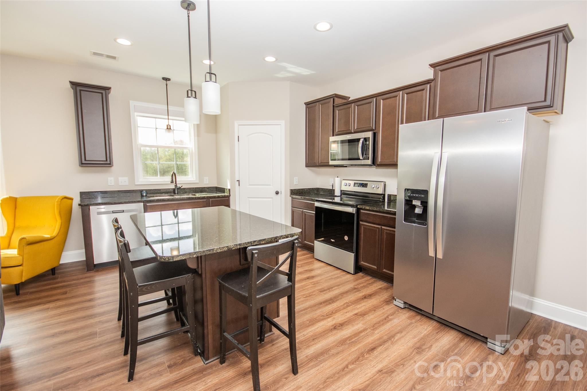 540 New Salem Road, Unit 1011 Statesville, NC 28625 - Photo 27 of 36 a kitchen with stainless steel appliances granite countertop a kitchen island hardwood floor and a sink