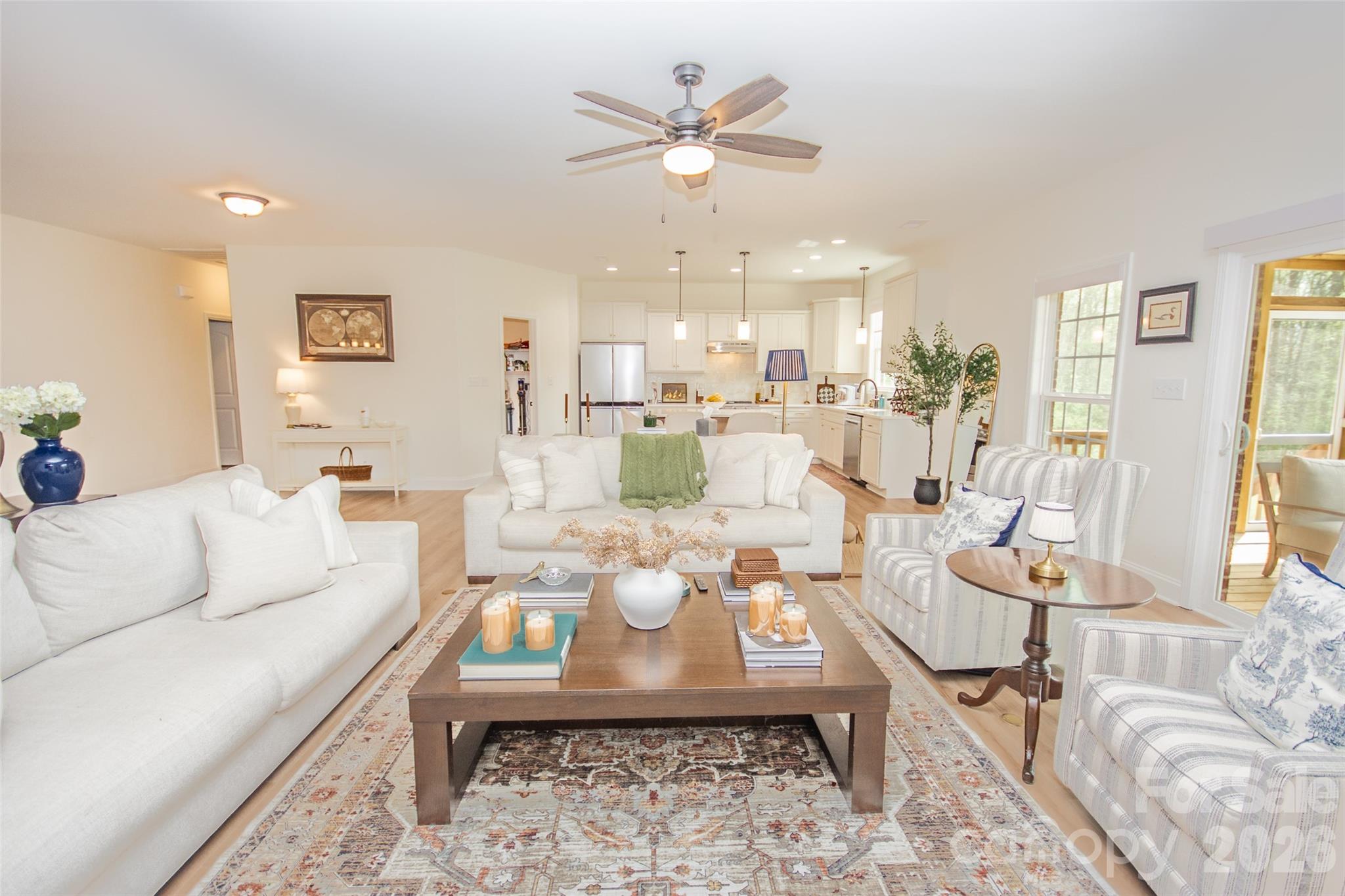 540 New Salem Road, Unit 1011 Statesville, NC 28625 - Photo 7 of 36 a living room with furniture a large window and a chandelier