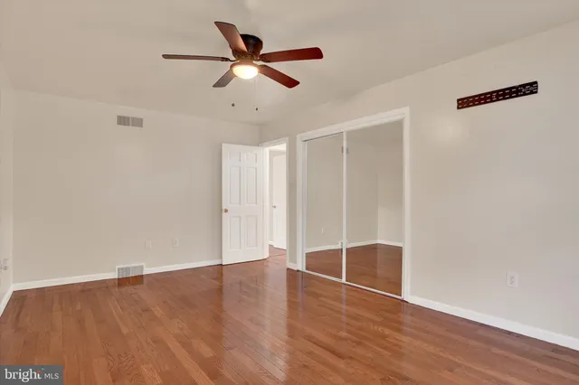 a bathroom with a granite countertop sink a toilet and a mirror
