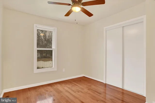 a view of a house with a big yard and large tree