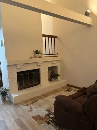 a bedroom with a bed and a fireplace