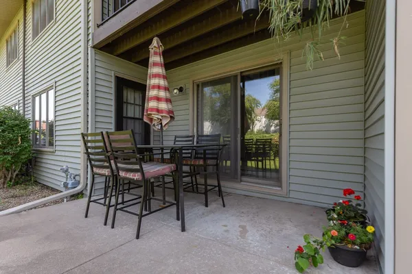 a view of a patio with a table and chairs and potted plants