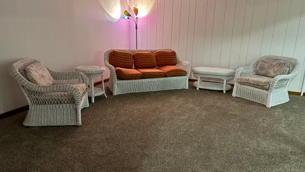 a living room with furniture and a lamp
