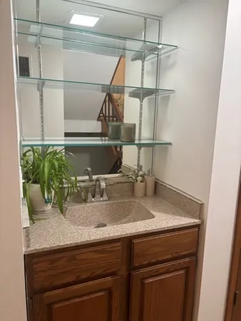 a bathroom with a sink and a mirror
