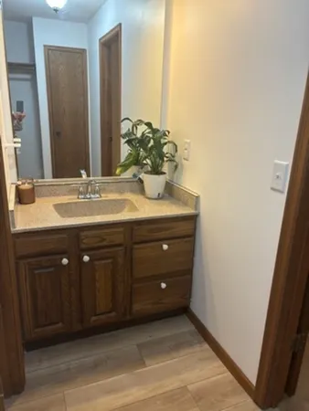 a spacious bathroom with a sink and a mirror
