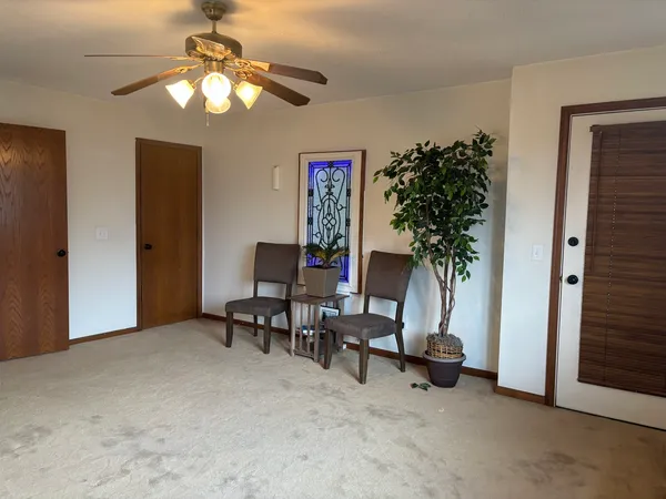 a view of a workspace with furniture and a chandelier fan