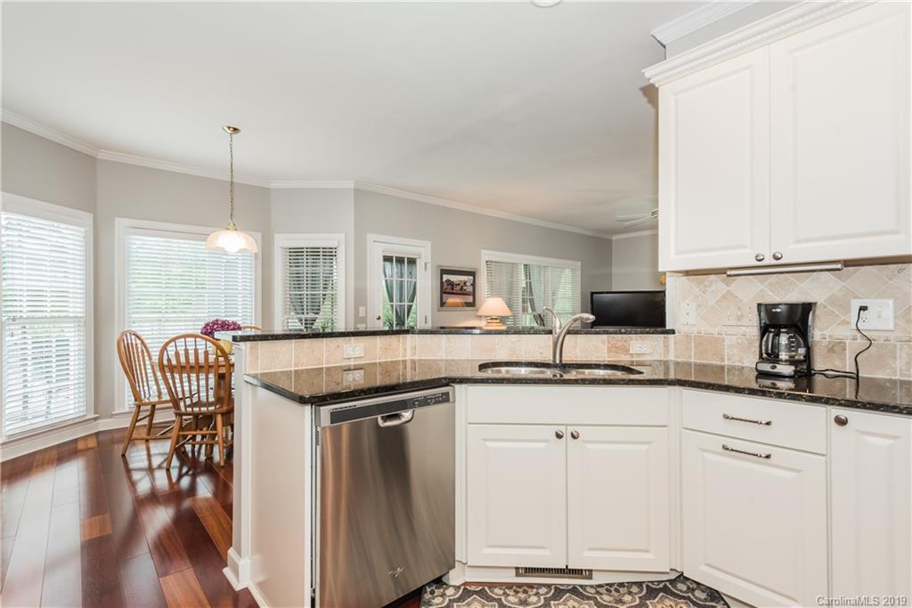 3310 Blue Jay Pass Fort Mill, SC 29708 - Photo 11 of 40 a kitchen with granite countertop a sink a counter space appliances and cabinets
