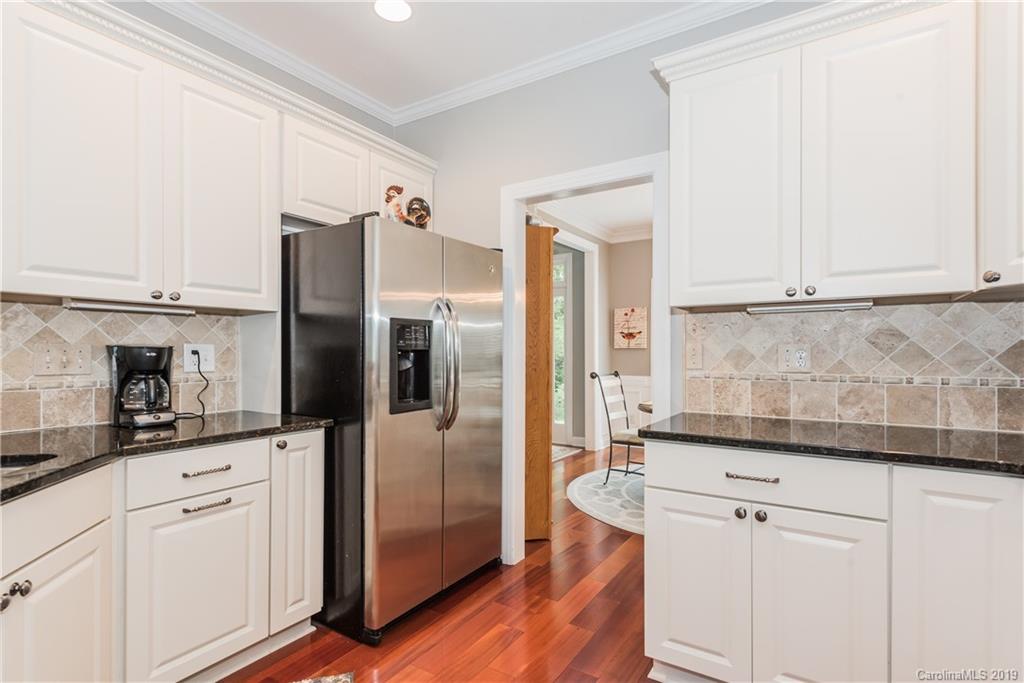 3310 Blue Jay Pass Fort Mill, SC 29708 - Photo 12 of 40 a kitchen with granite countertop white cabinets and stainless steel appliances