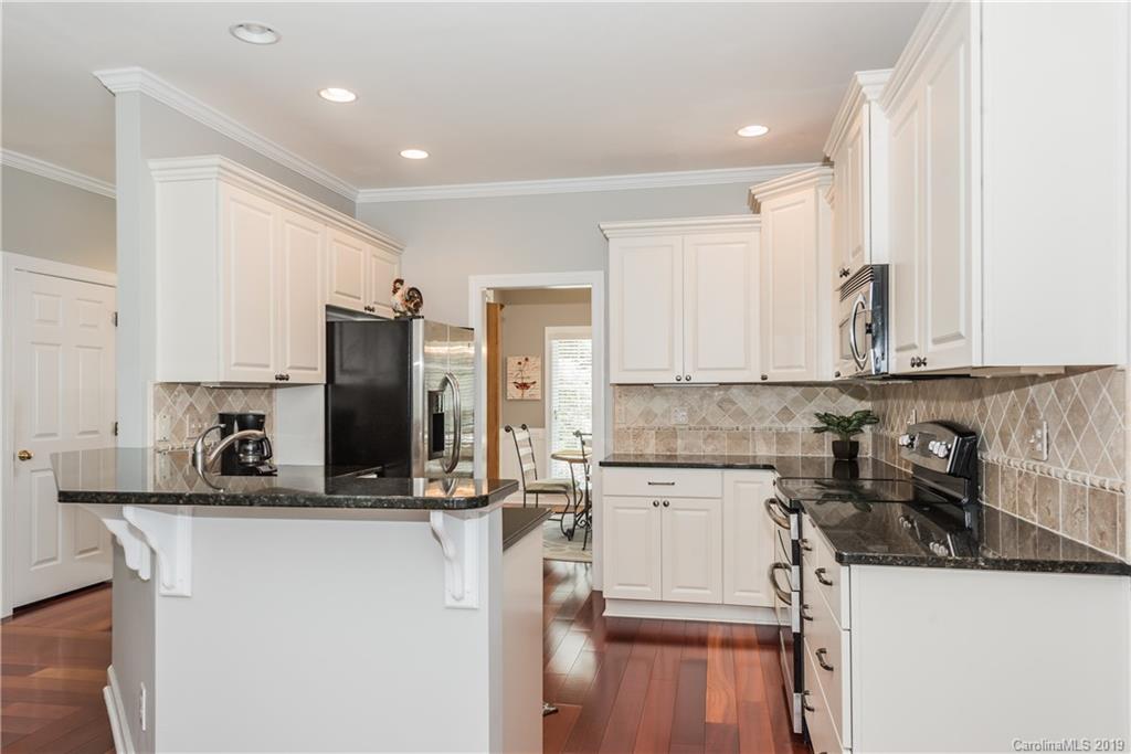 3310 Blue Jay Pass Fort Mill, SC 29708 - Photo 13 of 40 a kitchen with stainless steel appliances granite countertop a sink stove and refrigerator