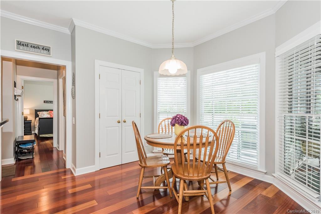 3310 Blue Jay Pass Fort Mill, SC 29708 - Photo 14 of 40 a dining room with furniture a chandelier and wooden floor