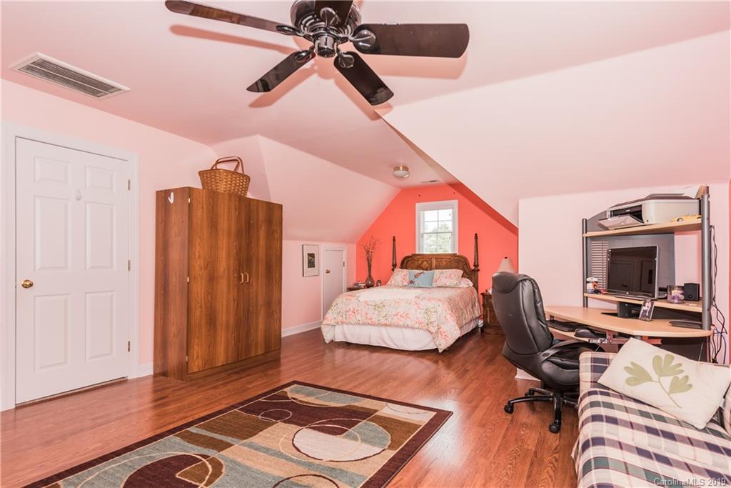3310 Blue Jay Pass Fort Mill, SC 29708 - Photo 29 of 40 a bedroom with a bed and a chandelier
