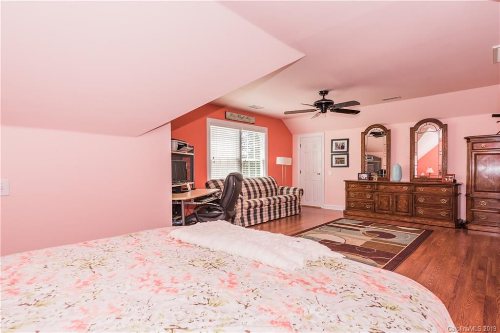 3310 Blue Jay Pass Fort Mill, SC 29708 - Photo 30 of 40 a bedroom with a bed and a dresser with mirror