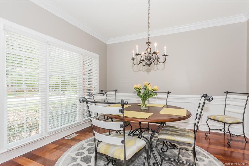3310 Blue Jay Pass Fort Mill, SC 29708 - Photo 8 of 40 a dining room with furniture a rug and a chandelier
