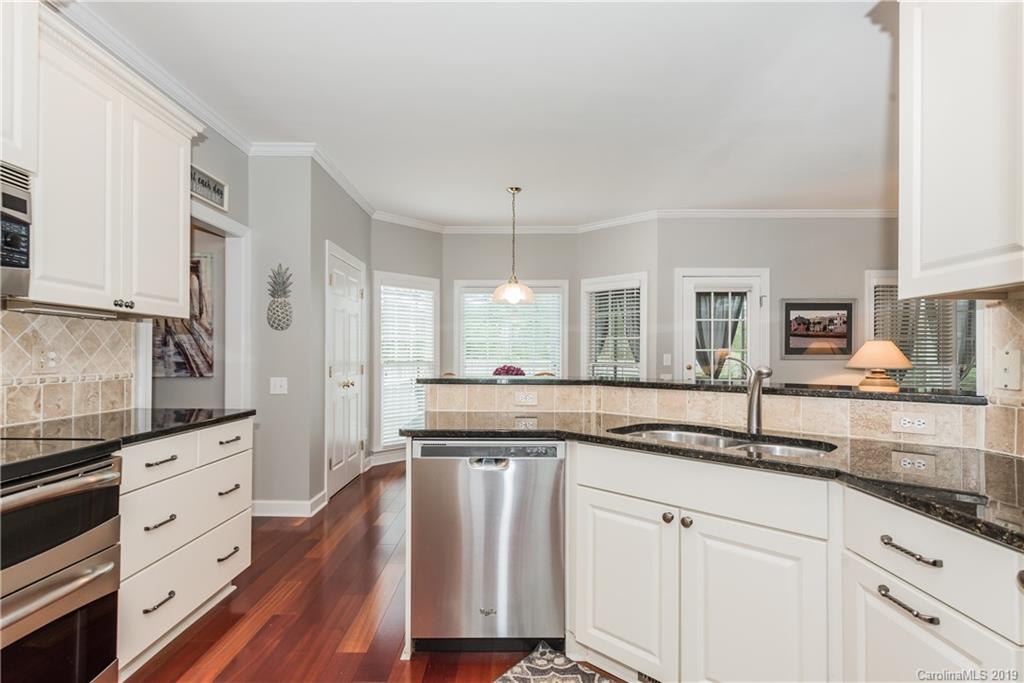 3310 Blue Jay Pass Fort Mill, SC 29708 - Photo 10 of 40 a kitchen with granite countertop white cabinets and white appliances