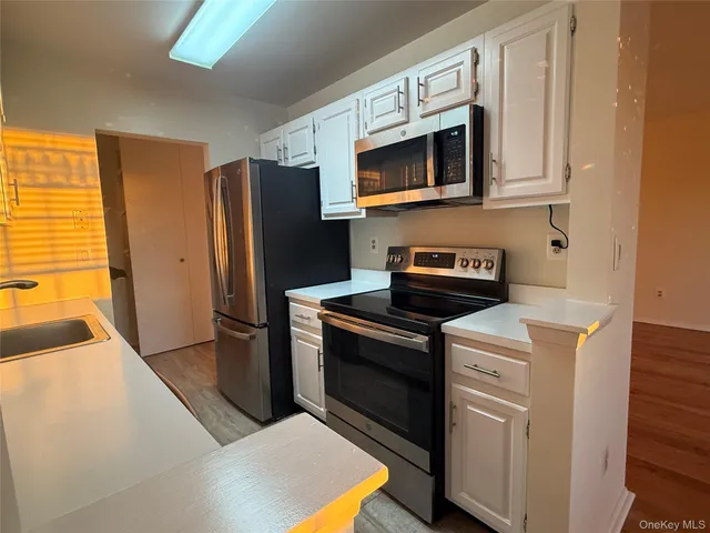 a kitchen with stainless steel appliances granite countertop a refrigerator stove and microwave
