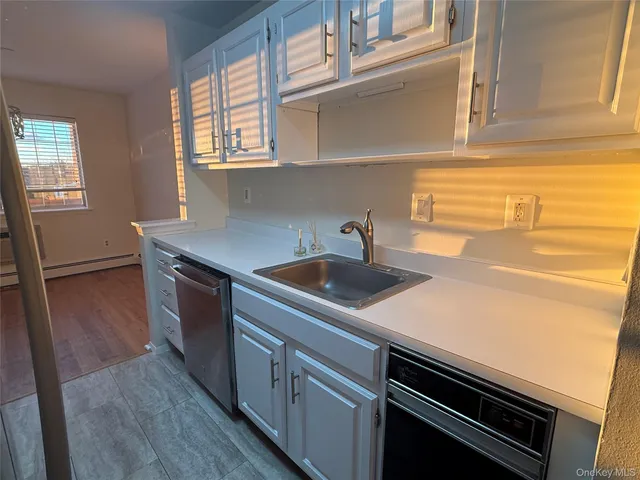 a kitchen with stainless steel appliances a sink and cabinets