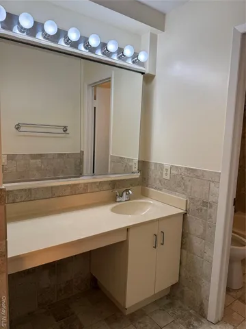 a bathroom with a sink a vanity and a mirror