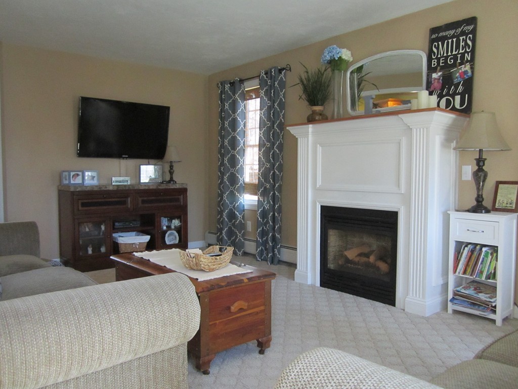 3 A Oakham Road North Brookfield, MA 01535 - Photo 12 of 26 a living room with furniture a fireplace and a flat screen tv