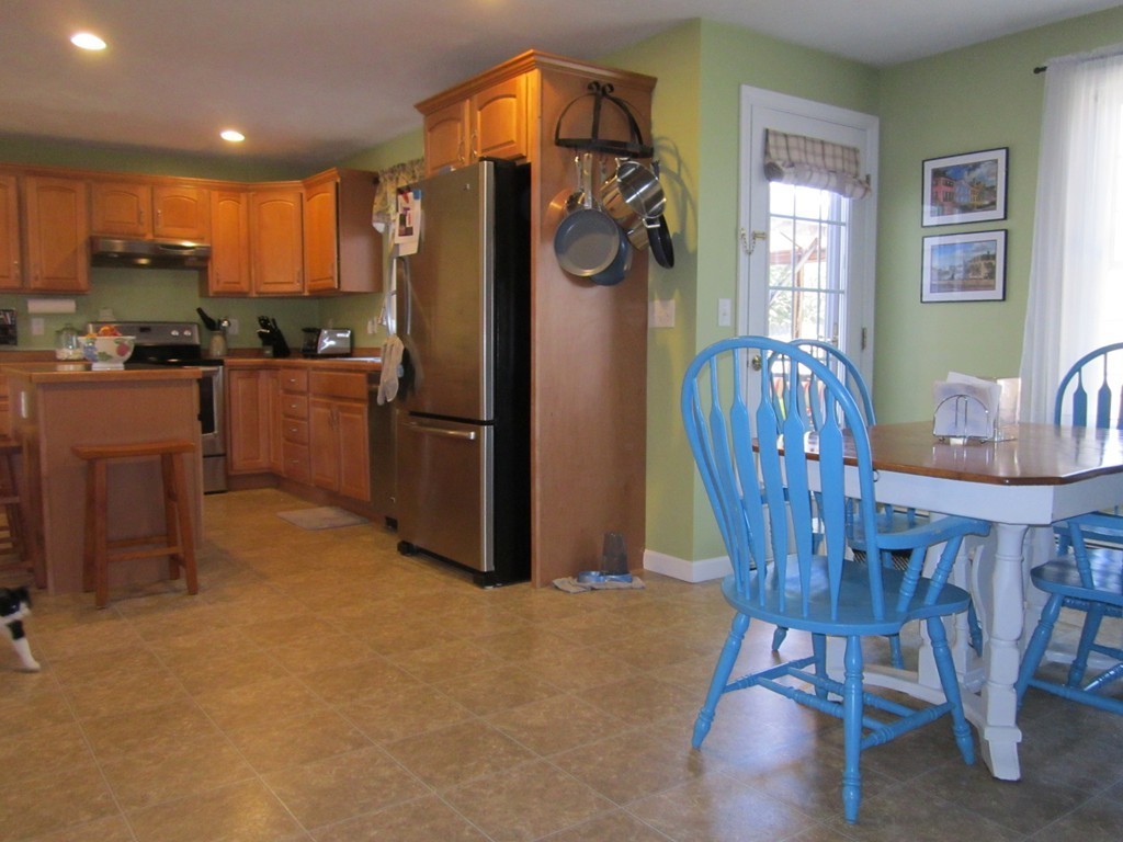 3 A Oakham Road North Brookfield, MA 01535 - Photo 8 of 26 a kitchen with refrigerator a dining table and chairs