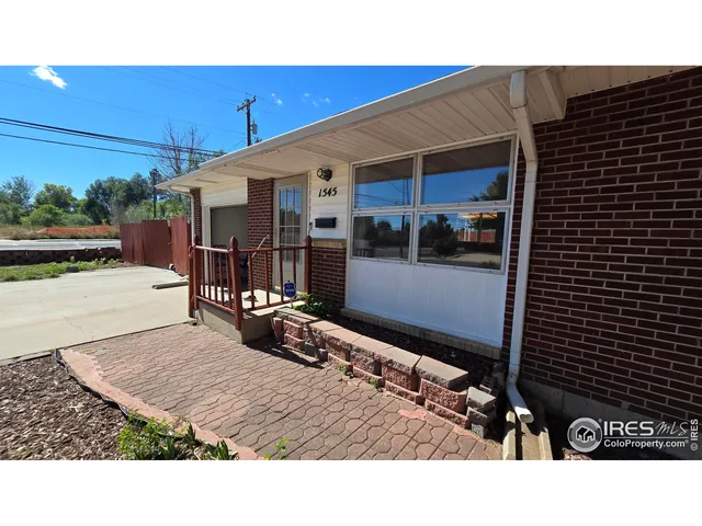 a view of backyard with a patio