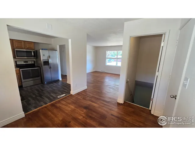 a living room with a bed furniture and a window