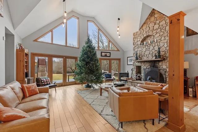 a living room with patio furniture and a fireplace