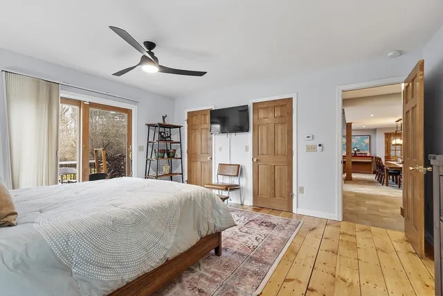 a bedroom with a large bed and a large window