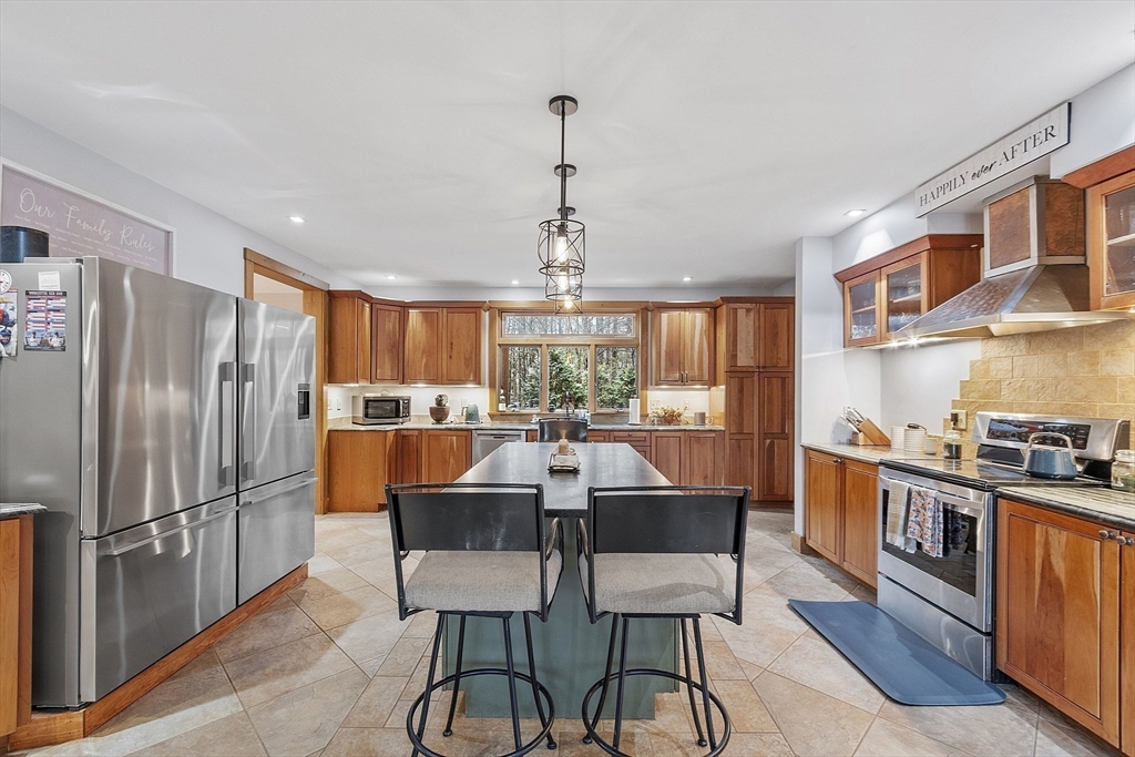 287 Chapman Road, Unit 1 Barre, MA 01005 - Photo 2 of 38 a kitchen with stainless steel appliances granite countertop a dining table chairs refrigerator and cabinets