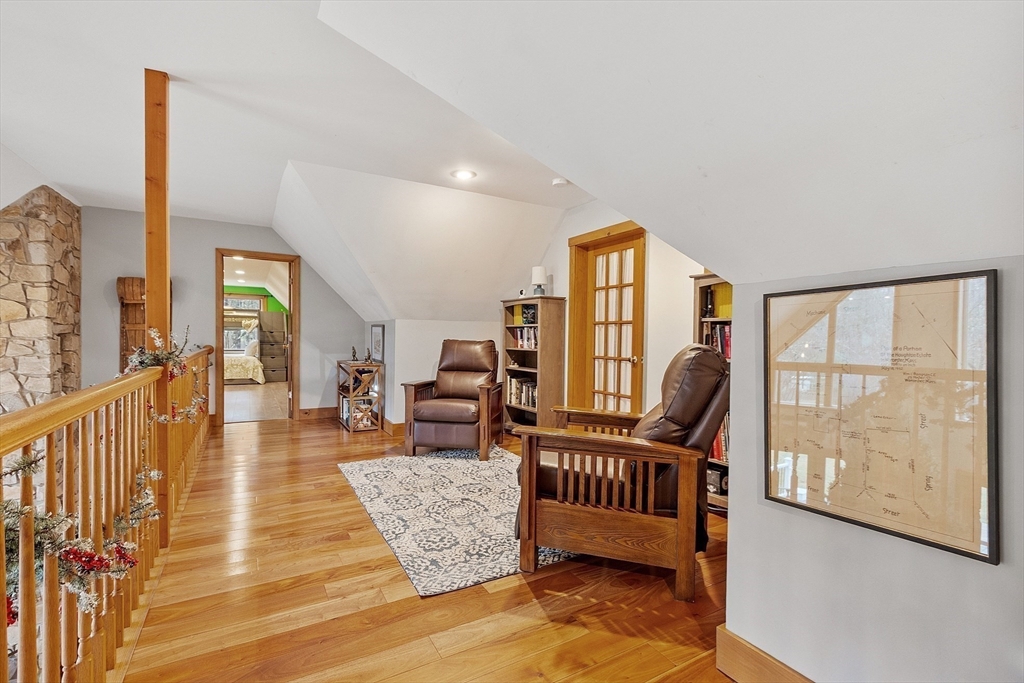 287 Chapman Road, Unit 1 Barre, MA 01005 - Photo 21 of 38 a balcony with chairs and a potted plant on a table