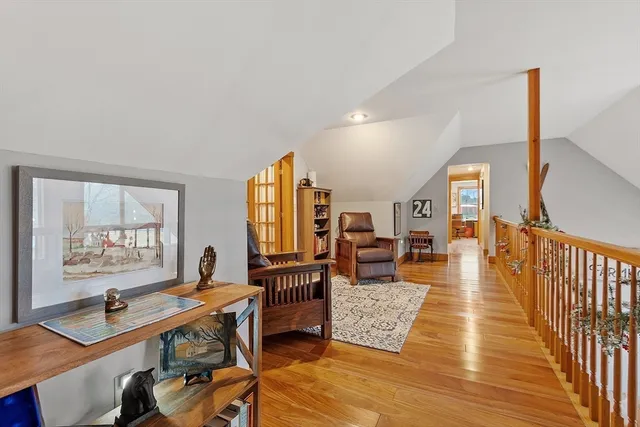 a living room with furniture and a book shelf