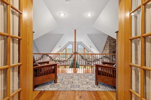 a living room with furniture a rug and a floor to ceiling window