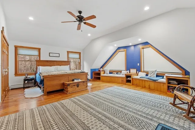 a bedroom with a bed and wooden floor