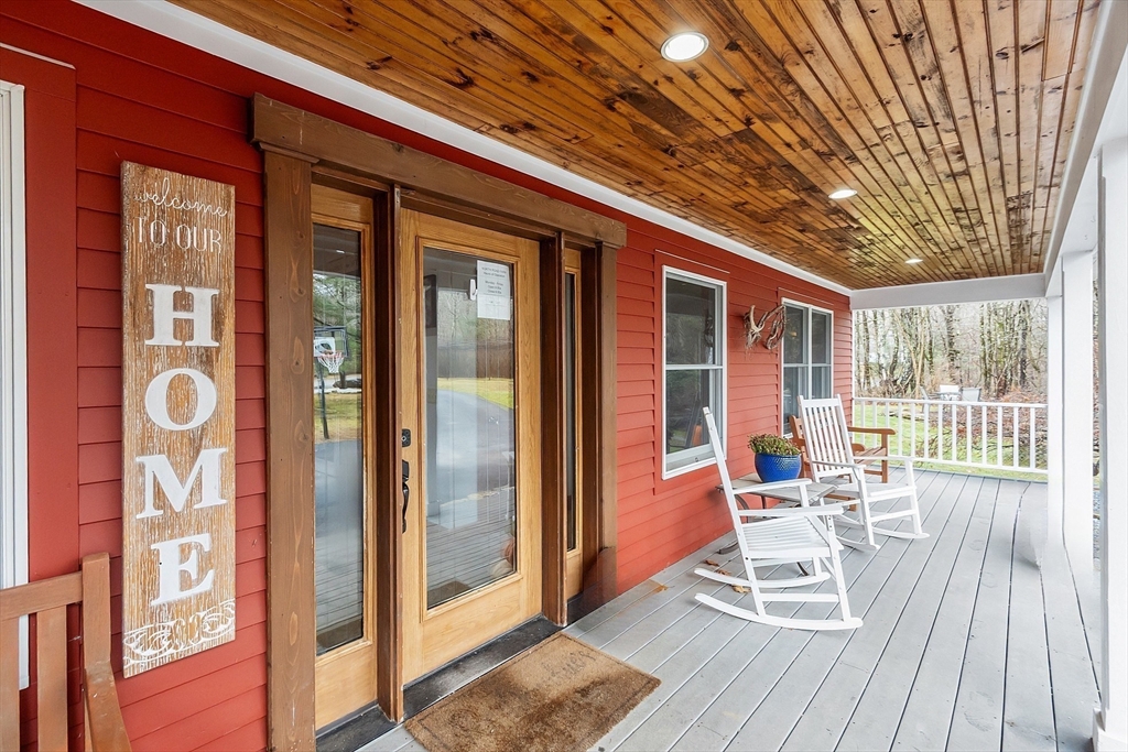 287 Chapman Road, Unit 1 Barre, MA 01005 - Photo 30 of 38 a porch with a table and chairs