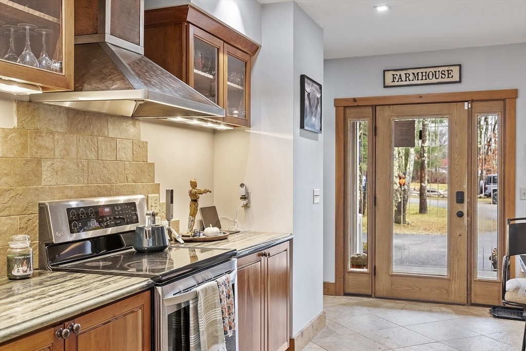 287 Chapman Road, Unit 1 Barre, MA 01005 - Photo 3 of 38 a kitchen with stainless steel appliances granite countertop a refrigerator and a stove