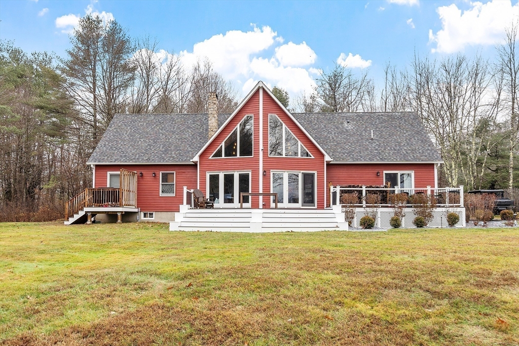 287 Chapman Road, Unit 1 Barre, MA 01005 - Photo 31 of 38 a front view of a house with a yard and garage