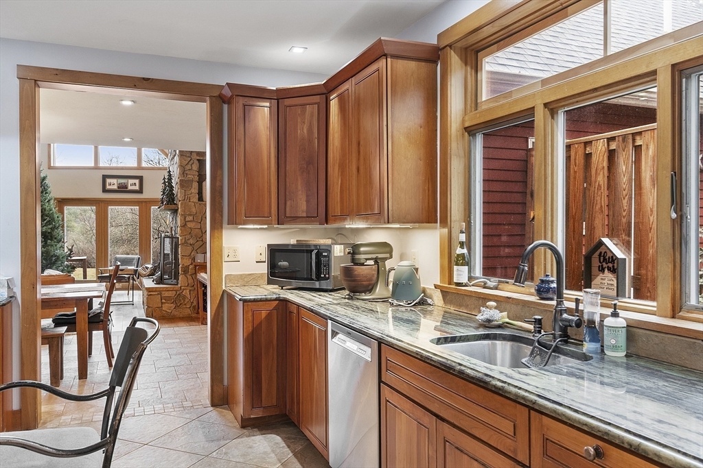 287 Chapman Road, Unit 1 Barre, MA 01005 - Photo 5 of 38 a kitchen with kitchen island granite countertop a sink counter top space appliances and cabinets