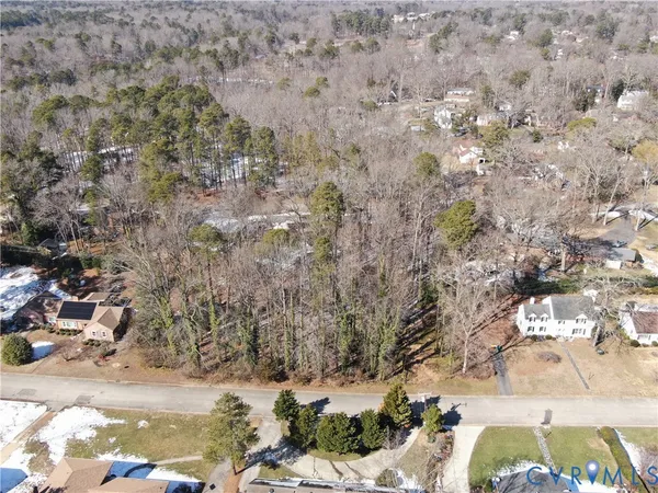 a view of lot of trees with yard