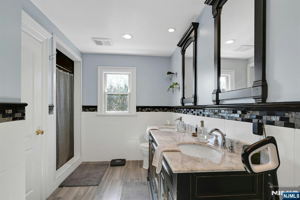 285 Chestnut Ridge Road Woodcliff Lake, NJ 07677 - Photo 33 of 46 a bathroom with a sink and a mirror