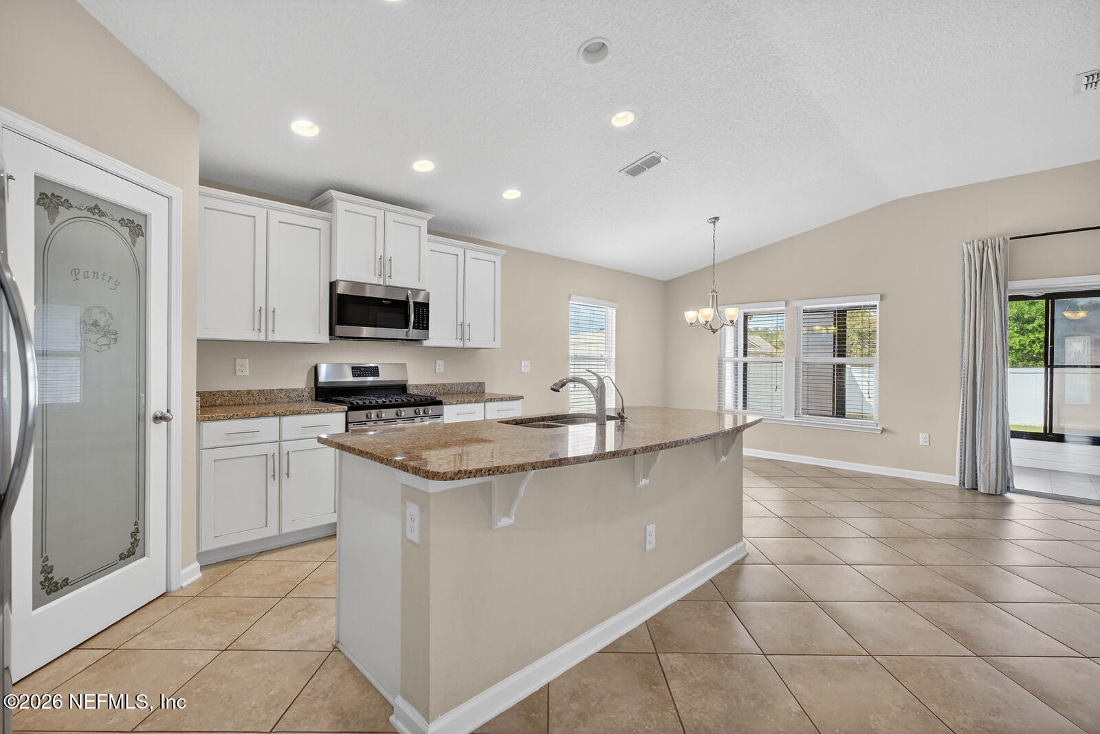353 Green Turtle Lane St. Augustine, FL 32086 - Photo 17 of 48 a kitchen with stainless steel appliances granite countertop a refrigerator sink and stove