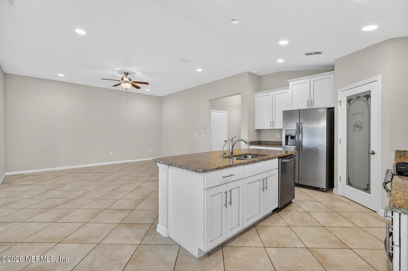 353 Green Turtle Lane St. Augustine, FL 32086 - Photo 18 of 48 a kitchen with a sink a refrigerator and white cabinets