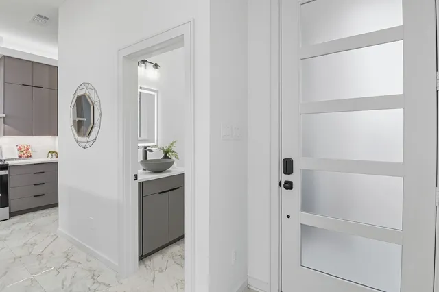 a kitchen with stainless steel appliances kitchen island hardwood floor and a sink