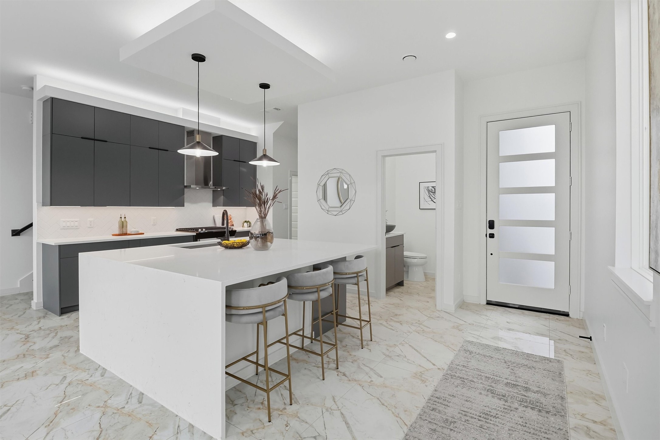 2939 El Fenice Lane Houston, TX 77057 - Photo 14 of 48 a kitchen with stainless steel appliances kitchen island hardwood floor and a sink