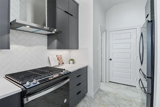 a kitchen with stainless steel appliances granite countertop a stove and a refrigerator
