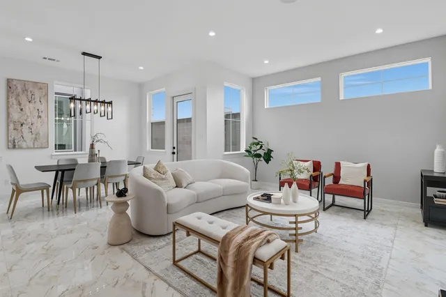 a living room with furniture a clock and a lamp