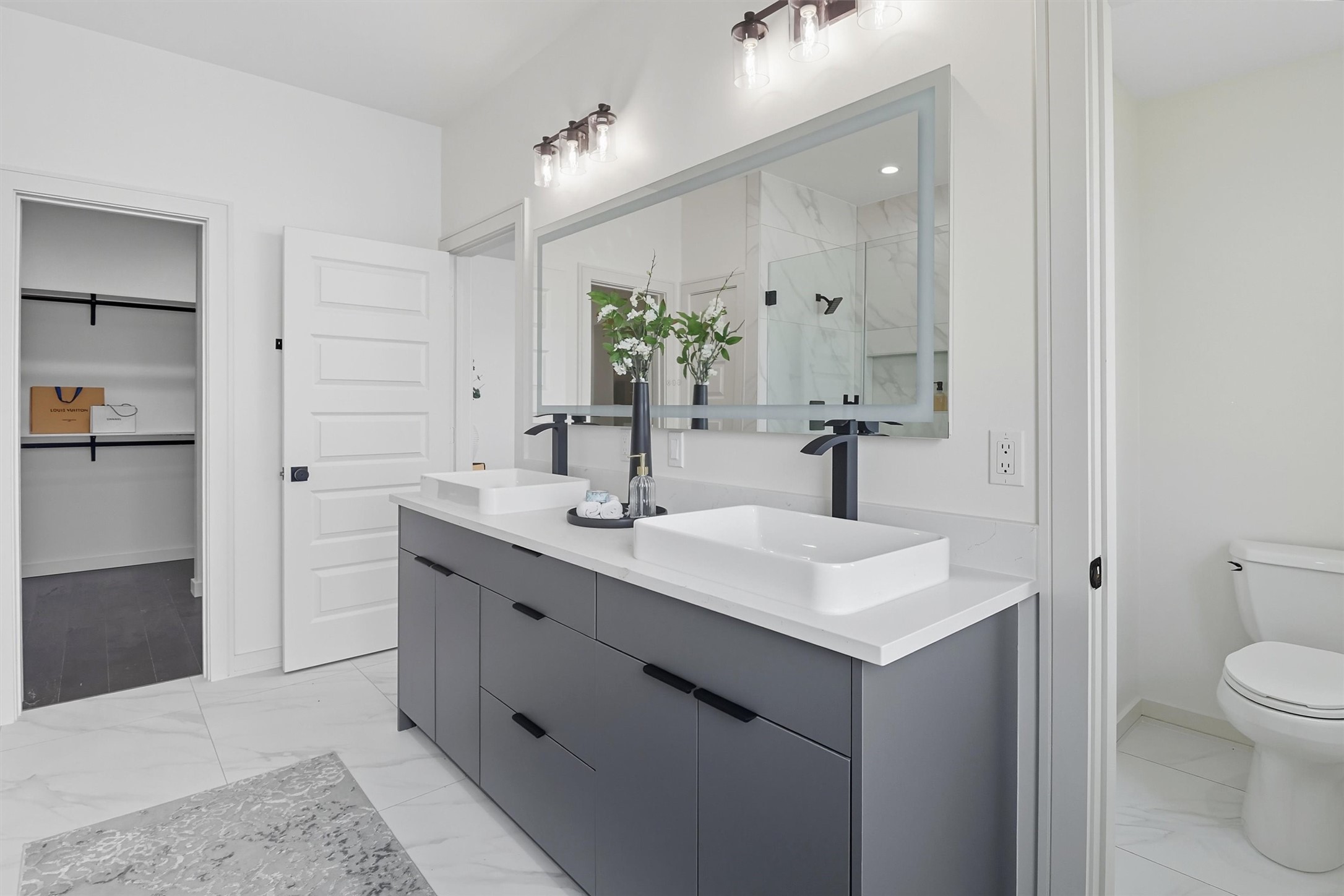 2939 El Fenice Lane Houston, TX 77057 - Photo 30 of 48 a bathroom with a sink a toilet and shower